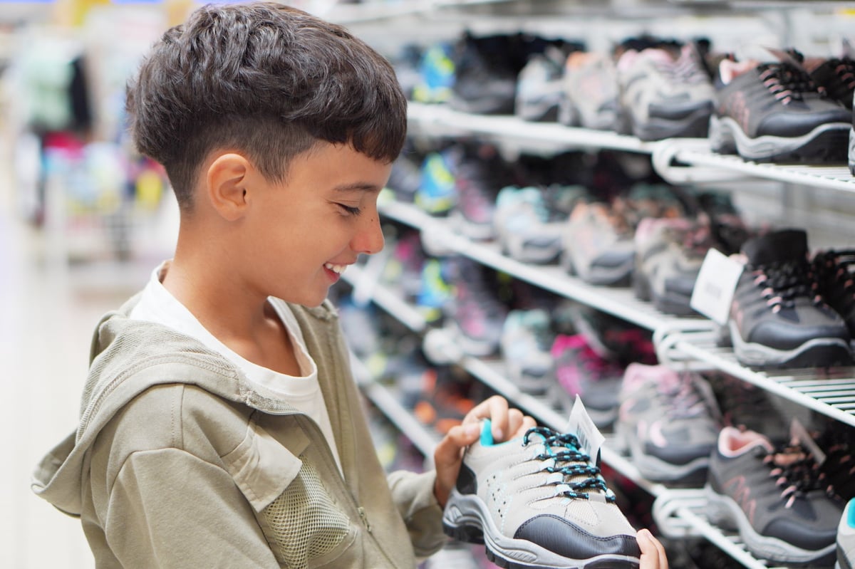 Teen choosing colorful sneakers at a retail clearance