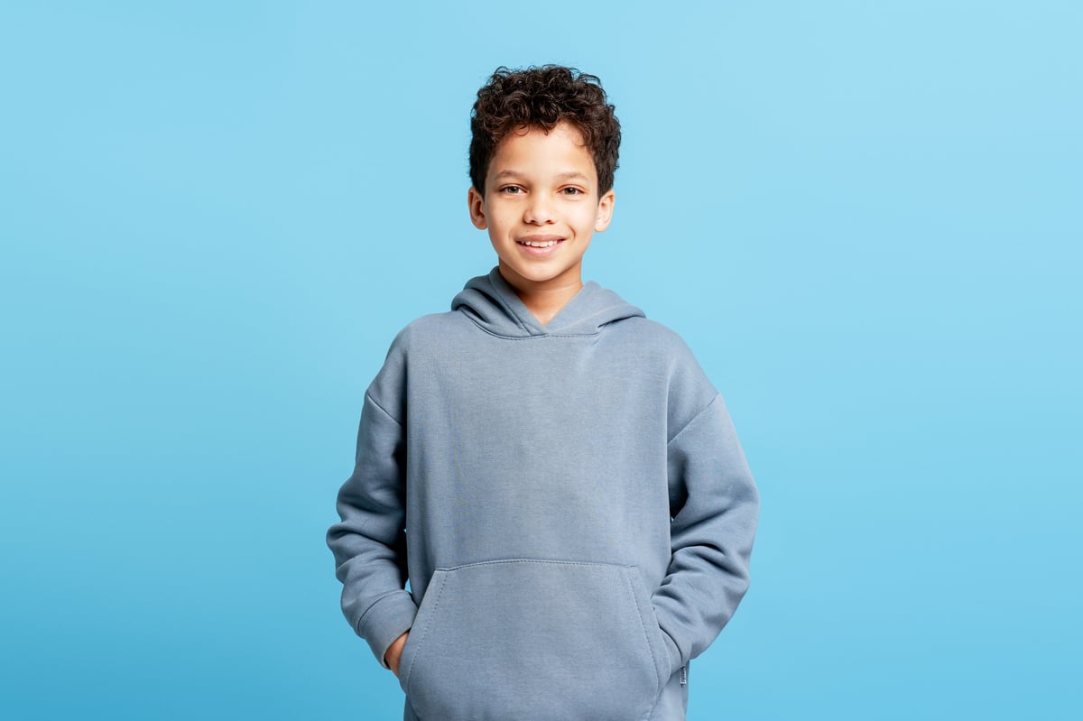 Happy smiling boy in casual hoodie-style clothing
