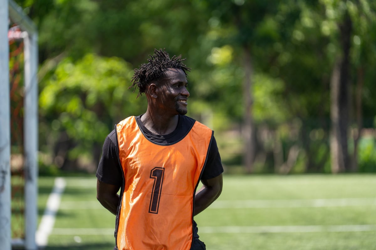 Black male athlete in a sports jersey training hard