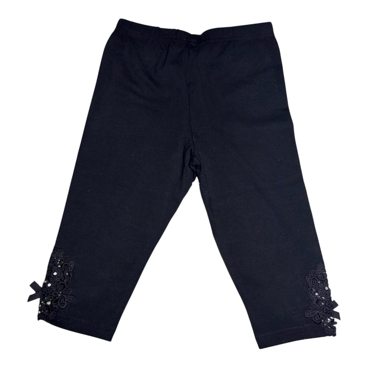 Black cropped pants with decorative beaded cuffs and bows at the ankles
