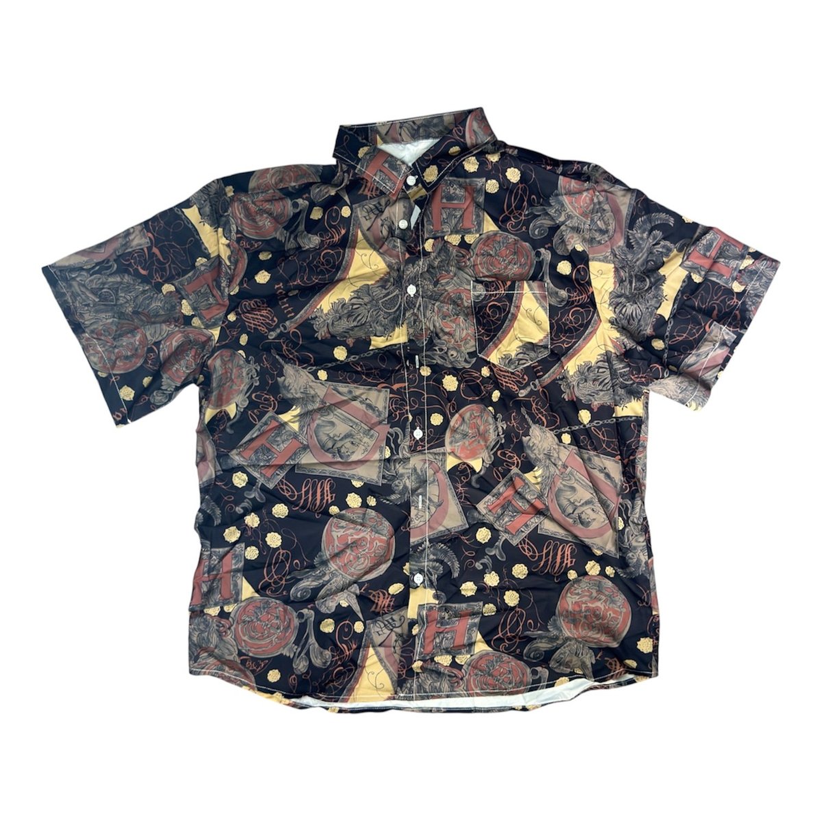 Short-sleeve patterned button-up shirt with ornate beige and burgundy designs on black background, front view